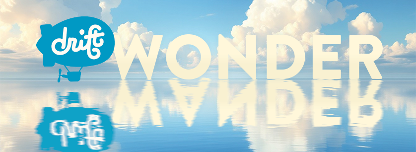 Drift logo with 'WONDER' text floating above water and 'WANDER' text reflected in water, against a blue sky with clouds.